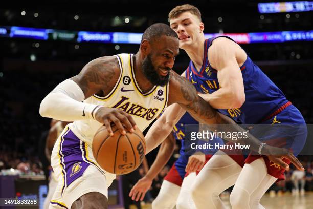 LeBron James of the Los Angeles Lakers drives to the basket against Christian Braun of the Denver Nuggets during the first quarter in game three of...