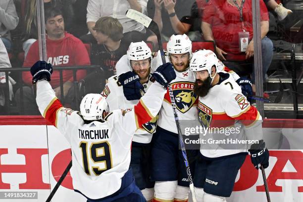 Aleksander Barkov of the Florida Panthers celebrates with his teammates after scoring a goal on Antti Raanta of the Carolina Hurricanes during the...