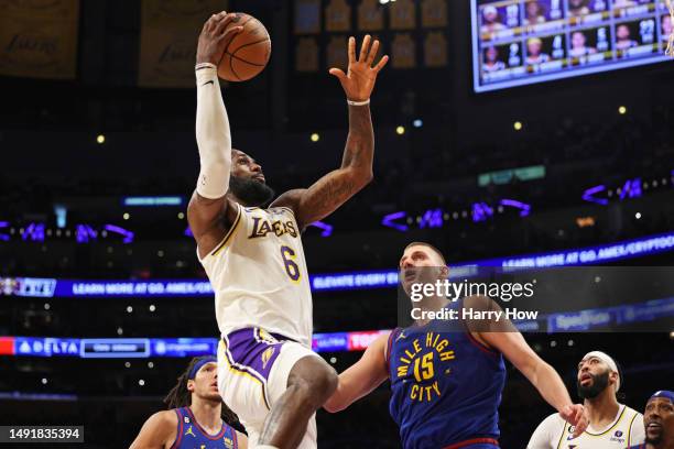 LeBron James of the Los Angeles Lakers shoots the ball against Nikola Jokic of the Denver Nuggets during the second quarter in game three of the...