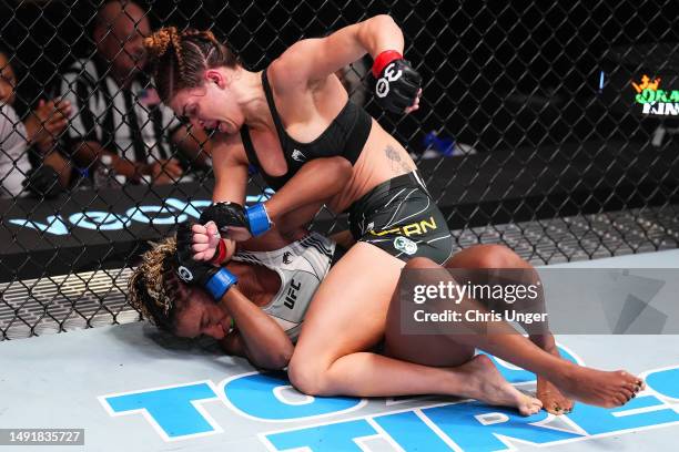 Mackenzie Dern punches Angela Hill in a strawweight fight during the UFC Fight Night event at UFC APEX on May 20, 2023 in Las Vegas, Nevada.