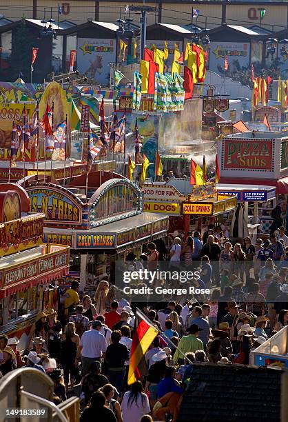 Thousands of people walk through the midway in Stampede Park, sampling foods such as pizza, hamburgers, and hot dogs on July 6, 2012 in Calgary,...