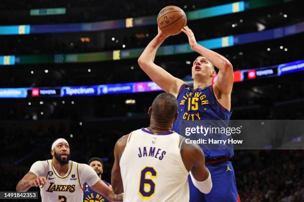 Nikola Jokic of the Denver Nuggets shoots the ball against LeBron James of the Los Angeles Lakers during the third quarter in game three of the...