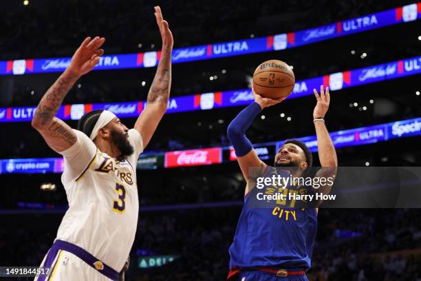 Jamal Murray of the Denver Nuggets shoots the ball against Anthony Davis of the Los Angeles Lakers during the third quarter in game three of the...