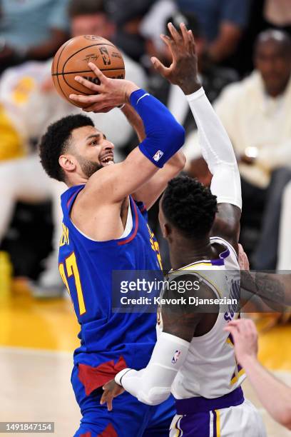Jamal Murray of the Denver Nuggets shoots the ball against Dennis Schroder of the Los Angeles Lakers during the fourth quarter in game three of the...