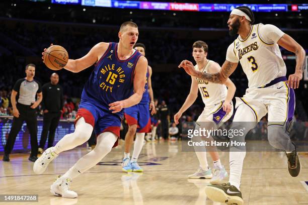 Nikola Jokic of the Denver Nuggets drives to the basket against Anthony Davis of the Los Angeles Lakers during the fourth quarter in game three of...