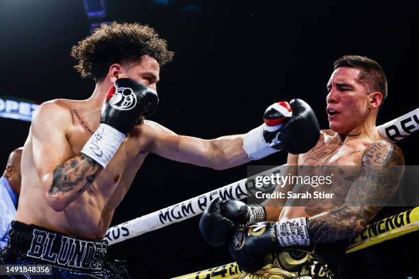 Oscar Valdez of Mexico exchanges punches with Adam Lopez during their junior lightweight bout at MGM Grand Garden Arena on May 20, 2023 in Las Vegas,...