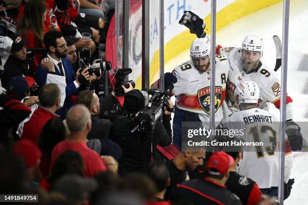 Matthew Tkachuk of the Florida Panthers celebrates with Sam Reinhart and Sam Bennett after scoring the game winning goal on Antti Raanta of the...