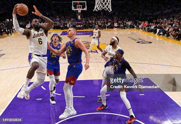LeBron James of the Los Angeles Lakers shoots the ball against Nikola Jokic of the Denver Nuggets during the second quarter in game three of the...