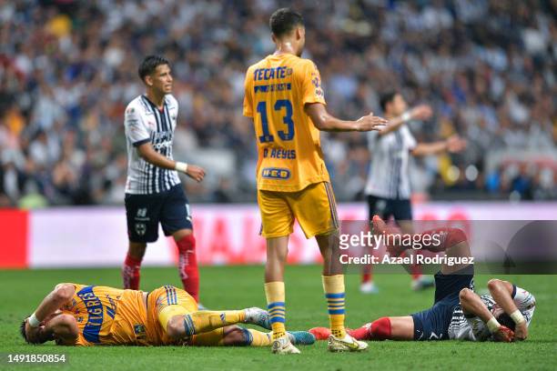 Rogelio Funes Mori of Monterrey and Jesus Angulo of Tigres lie on the ground after clash during the semifinals second leg match between Monterrey and...