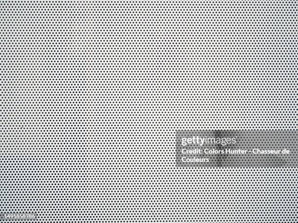close-up of a perforated metal plate painted white in brussels, belgium - spots stock pictures, royalty-free photos & images