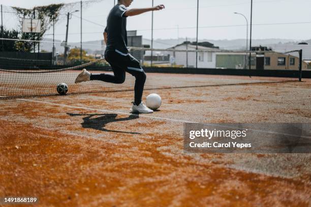 teenager boy playing football ready to kick the  ball - southern europe fotografías e imágenes de stock