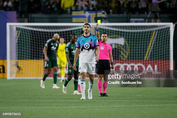 Michael Boxall of the Minnesota United receives a yellow card during the second half against the Portland Timbers at Providence Park on May 20, 2023...