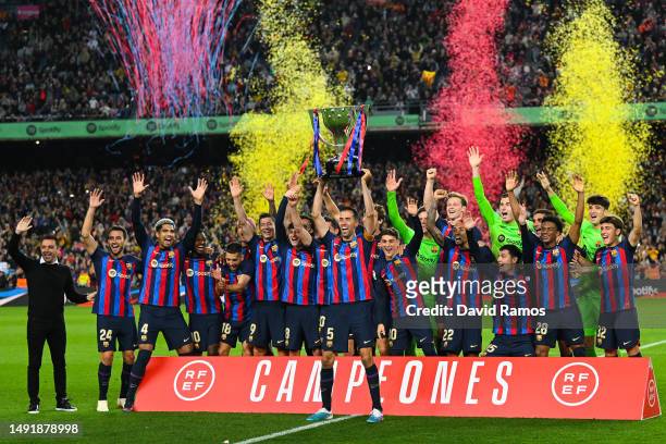 Sergio Busquets of FC Barcelona lifts the LaLiga Santander Trophy as players of FC Barcelona celebrate after being crowned League Champions after the...