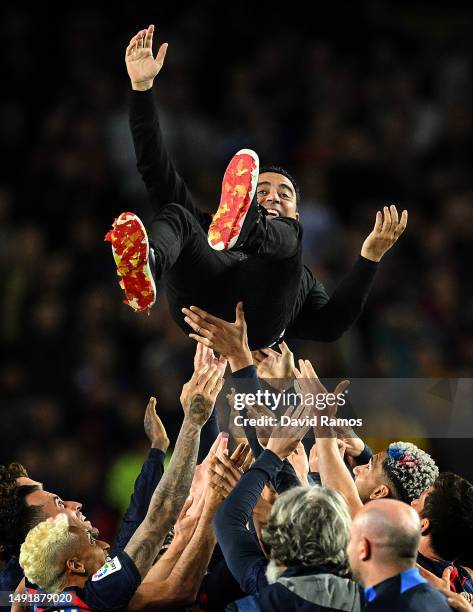 Head Coach of FC Barcelona Xavi Hernandez, is thrown into the air as players of FC Barcelona celebrate being crowned the League Champions of the...