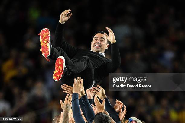 Head Coach of FC Barcelona Xavi Hernandez, is thrown into the air as players of FC Barcelona celebrate being crowned the League Champions of the...