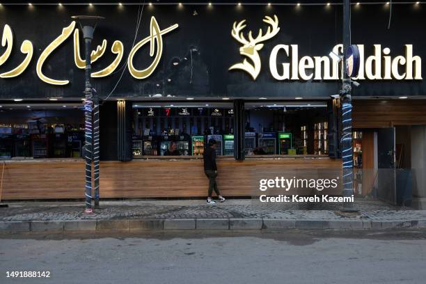 Liquor shop sells alcohol to customers despite the government ban on sale of alcoholic beverages on March 18, 2023 in Baghdad, Iraq.