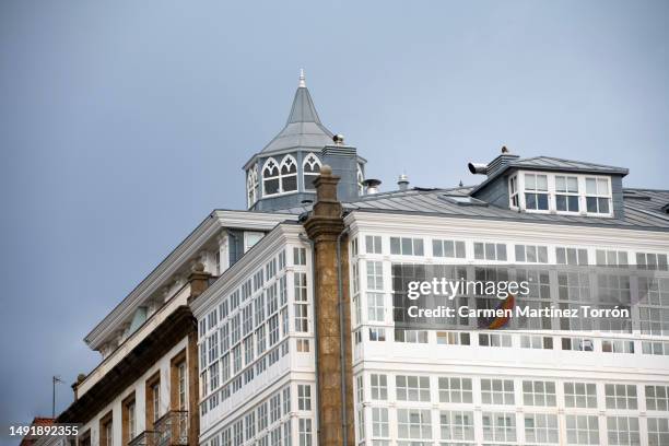 typical facade of galleries in a coruña, galicia with a lgtbia+ flag in the window. spain - la coru�ña imagens e fotografias de stock