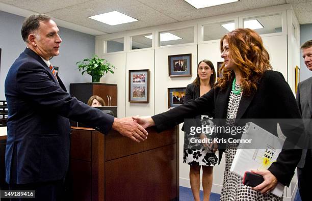 John Boozman and Debra Messing greet each other during the 19th International AIDS conference in the Hart Senate Office building on July 24, 2012 in...
