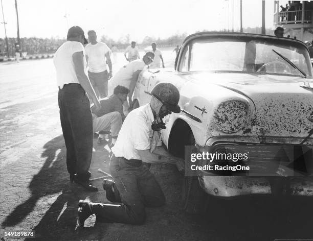 When you are a bit short on pit crewmembers, sometimes you have to change your own tire during a pit stop as driver Ewell Weddle does here during a...