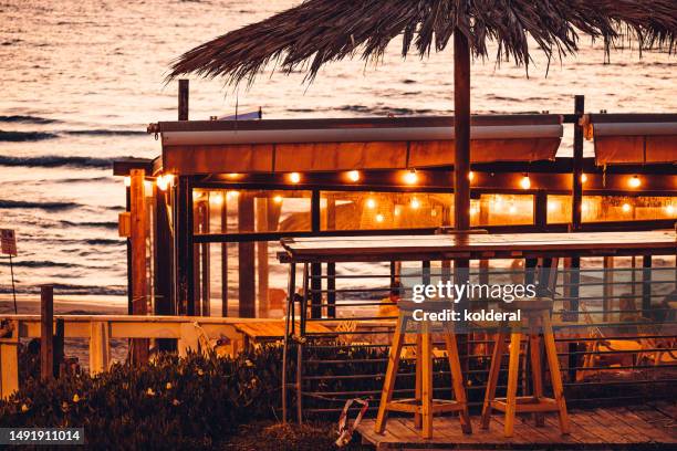 beach cafe at sunset - golden hour beach stock pictures, royalty-free photos & images