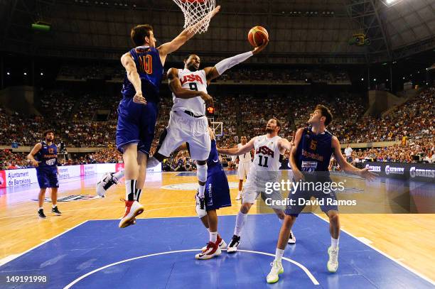 Andre Iguodala of the US Men's Senior National Team shoots against Victor Claver of the Spain Men's Senior National Team during a Pre-Olympic Men's...