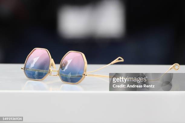 Sunglasses worn by Reda Kateb as he attends the "Omar La Fraise " photocall at the 76th annual Cannes film festival at Palais des Festivals on May...