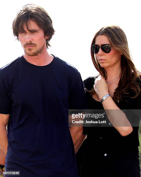 Actor Christian Bale and his wife Sandra Blazic visit the memorial across the street from the Century 16 movie theater July 24, 2012 in Aurora,...