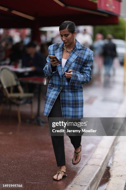 Film Festival Guest seen wearing a blue and black oversized plaid blazer, black wide pants, Dolce & Gabbana black sandals, silver necklace chain,...