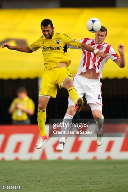 Justin Meram of the Columbus Crew and Robert Huth of Stoke City FC battle for control of the ball in the first half on July 24, 2012 at Crew Stadium...