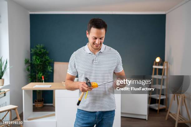 portrait of caucasian handyman, renovating his new apartment - handyman smiling imagens e fotografias de stock