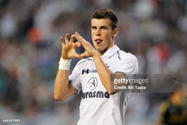 Gareth Bale of the Tottenham Hotspur celebrates his goal by making a heart shape with his hand in the first half during the international friendly...