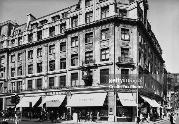 Pedestrians passing beneath the awnings of the Garrard store at 112 Regent Street in the West End of London, England, 26th July 1967.