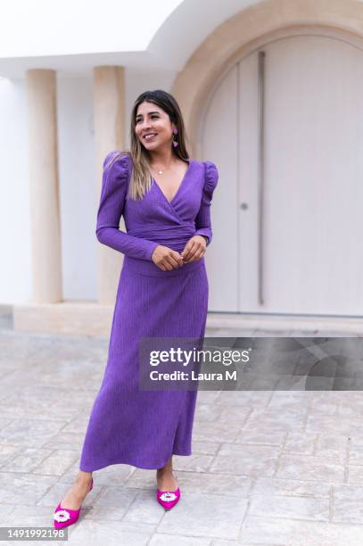 model posing with elegant purple dress outside a building - gown stock pictures, royalty-free photos & images