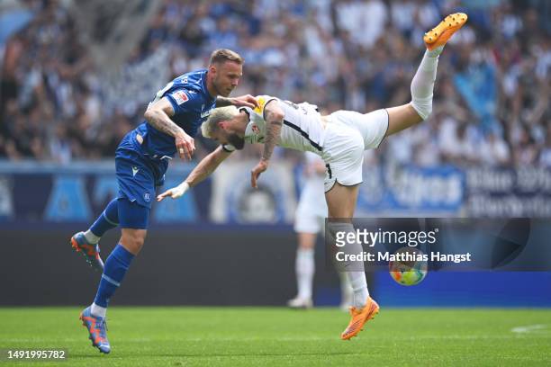 Lex-Tyger Lobinger of 1.FC Kaiserslautern battles for possession with Marcel Franke of Karlsruher SC during the Second Bundesliga match between...