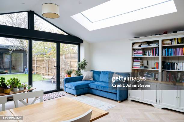 interior of living area of modern home extension with skylight and large patio doors - ampliação da casa imagens e fotografias de stock