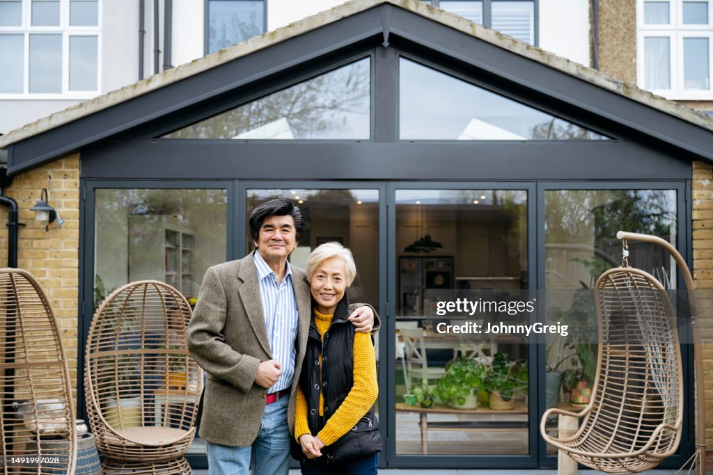 Portrait of a contented senior Chinese couple outdoors at home