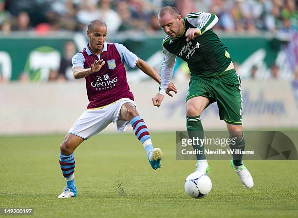 Karim El Ahmadi of Aston Villa challenges Kris Boyd of Portland Timbers during the pre-season friendly match between Portland Timbers and Aston Villa...