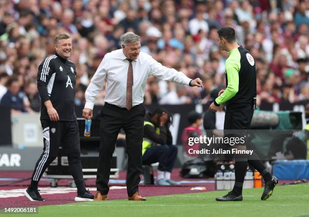 Sam Allardyce, Manager of Leeds United, attempts to give money to Fourth official, Andy Madley in jest during the Premier League match between West...