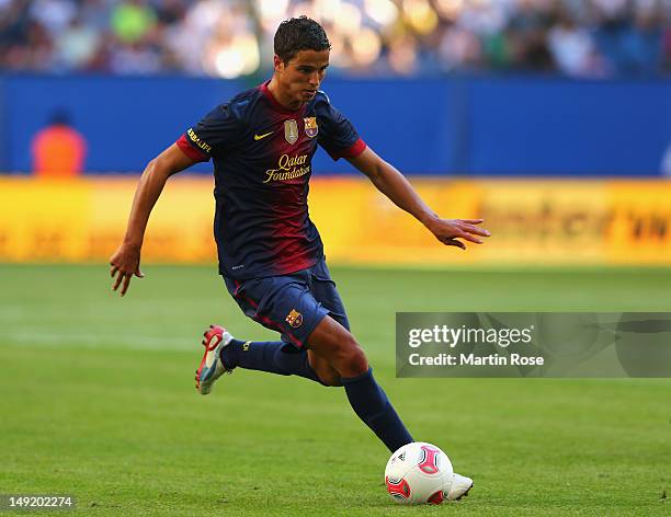 Ibrahim Afellay of Barcelona runs with the ball during the friendly match between Hamburger SV and FC barcelona at Imtech Arena on July 24, 2012 in...