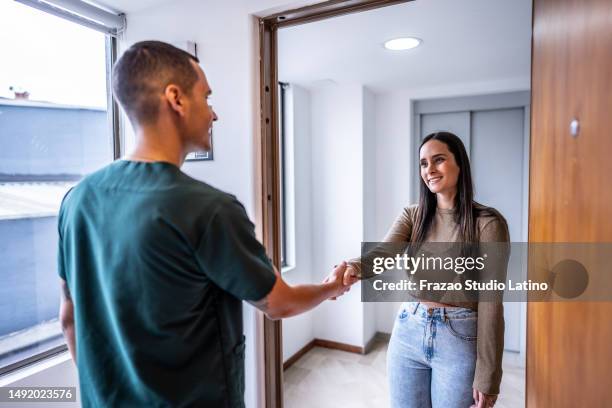 doctor/dentist greeting a mid adult woman patient at medical/dentistry clinic - röra mot bildbanksfoton och bilder