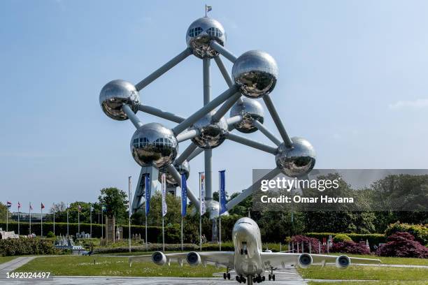 The Atomium is seen from the Concorde scale model which is part of the "Mini Europe" tourist attraction located just a few metres from the monument...