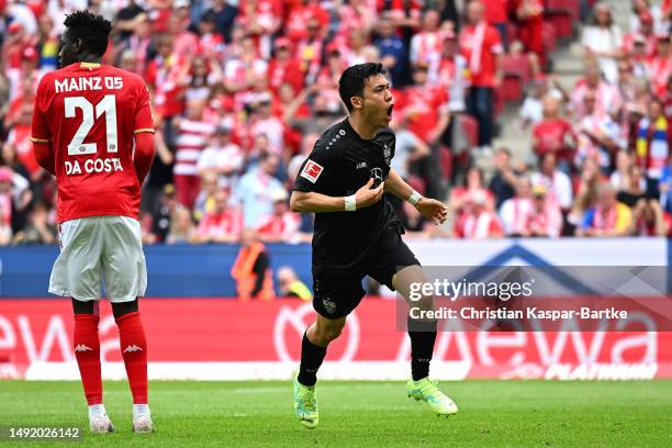 Wataru Endo of VfB Stuttgart celebrates after scoring the team's first goal during the Bundesliga match between 1. FSV Mainz 05 and VfB Stuttgart at...