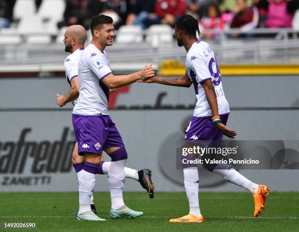 Luka Jovic of ACF Fiorentina celebrates with teammate Cristian Kouame after scoring the team's first goal during the Serie A match between Torino FC...