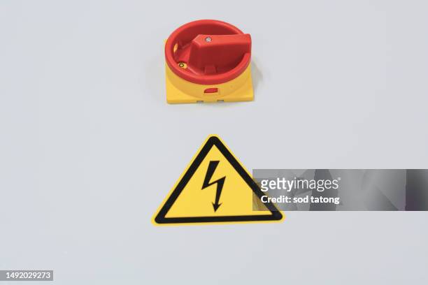 stop button and the hand of worker about to press it. emergency stop button. big red emergency button or stop button for manual pressing. - big red button stockfoto's en -beelden