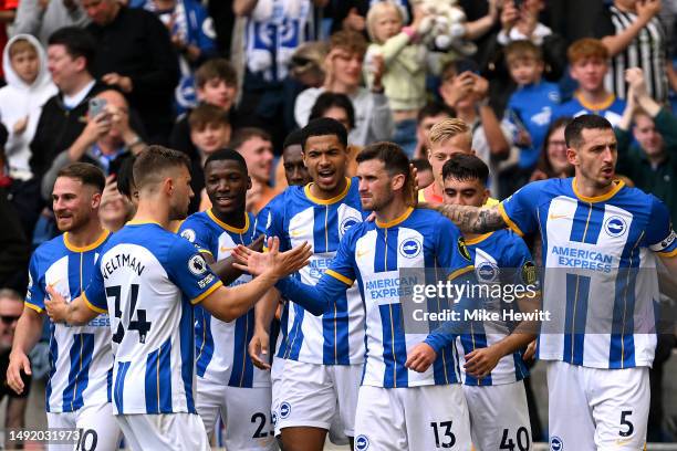 Pascal Gross of Brighton & Hove Albion celebrates with Levi Colwill, Joel Veltman and teammates after scoring the team's third goal during the...