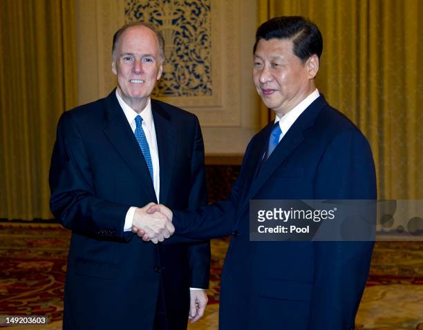 National Security Advisor Tom Donilon shakes hand with Chinese Vice President Xi Jinping before a meeting at the Zhongnanhai diplomatic compound, on...