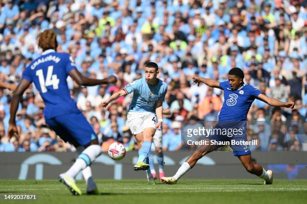 Phil Foden of Manchester City passes the ball whilst under pressure from Wesley Fofana of Chelsea during the Premier League match between Manchester...