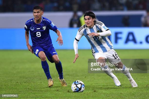Luka Romero of Argentina controls the ball against Bekhruzbek Askarov of Uzbekistan during the FIFA U-20 World Cup Argentina 2023 Group A match...