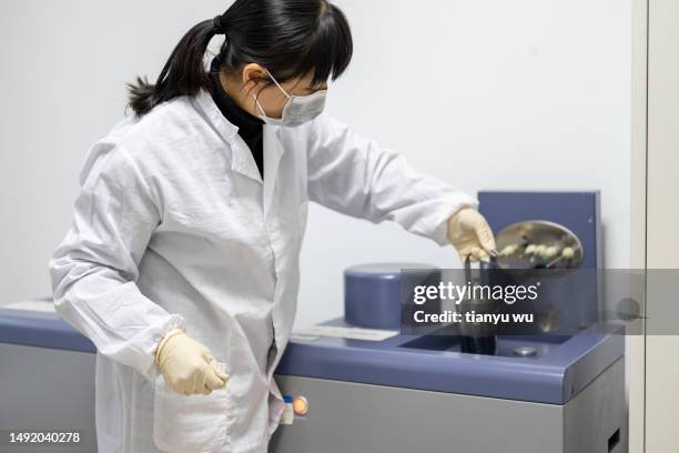 a female technician is conducting metal material testing using instruments in an industrial laboratory - lab safety signs stock pictures, royalty-free photos & images
