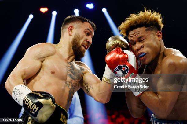 Devin Haney exchanges punches with Vasyl Lomachenko of Ukraine during their undisputed lightweight title bout at MGM Grand Garden Arena on May 20,...